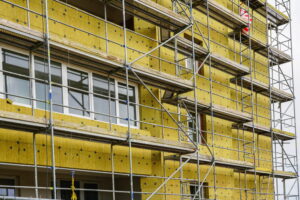 scaffolding arround the house to install thermal insulation of the apartment building facade