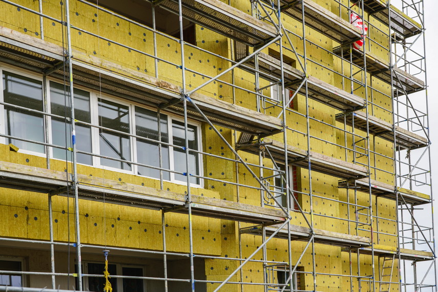 scaffolding arround the house to install thermal insulation of the apartment building facade